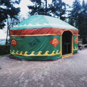 A yurt made of canvas and plastic with wave symbols and flower symbols on the surface. 